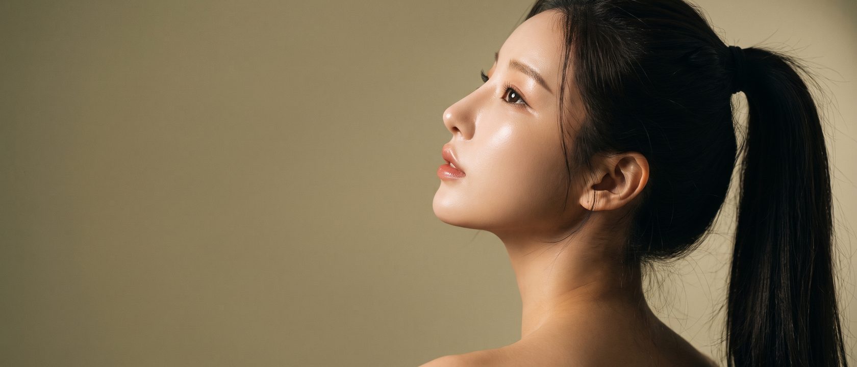 포니테일로 머리를 묶고 고개를 돌려 코와 입술 라인이 실루엣으로 드러난 뷰티 컷 (AI 생성 예시 이미지)