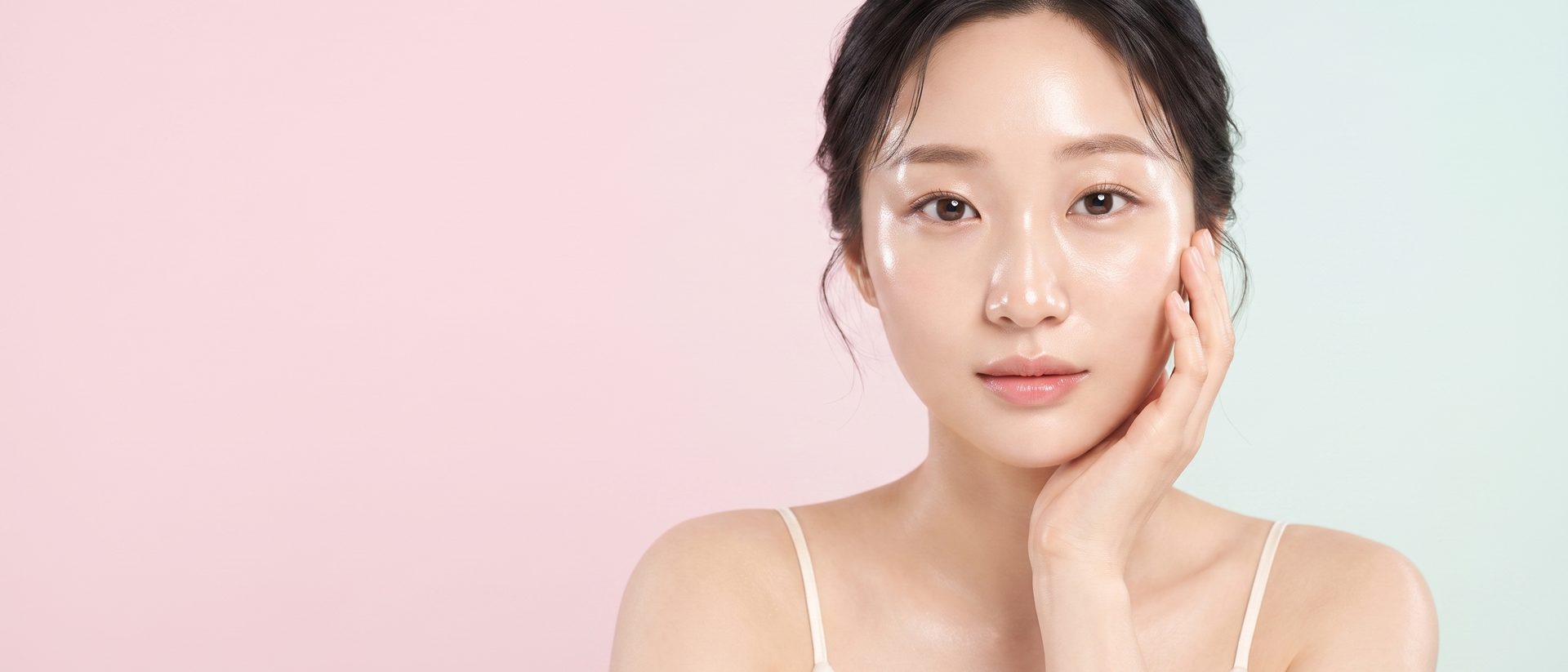 파스텔 핑크에서 민트로 이어지는 배경 앞에서 한 손을 볼에 얹은 리뷰티 가상 모델 (AI 생성 예시 이미지)